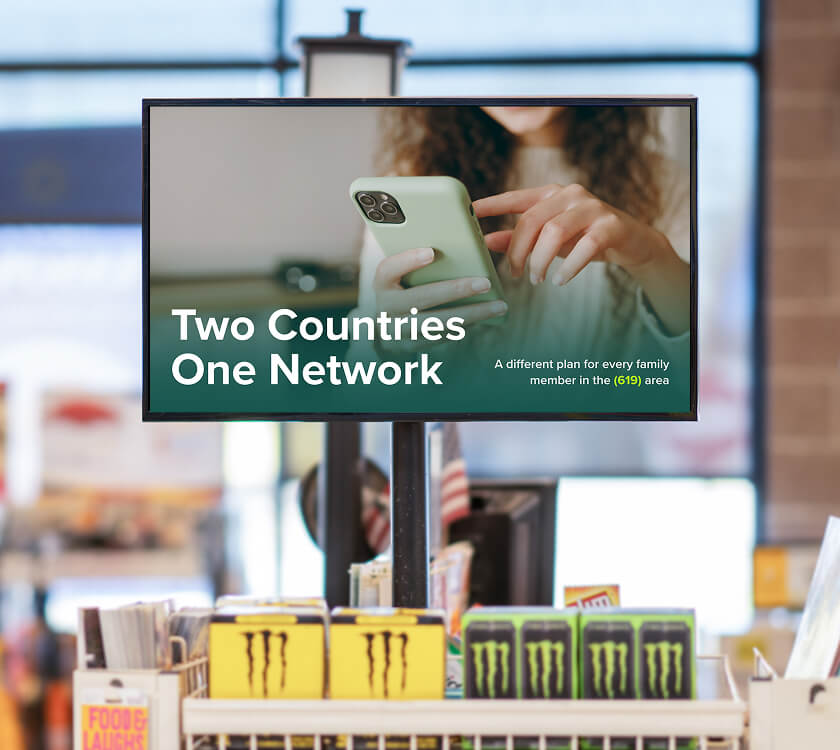 Image of a digital screen showcasing a telecom brand at the grocery store front end