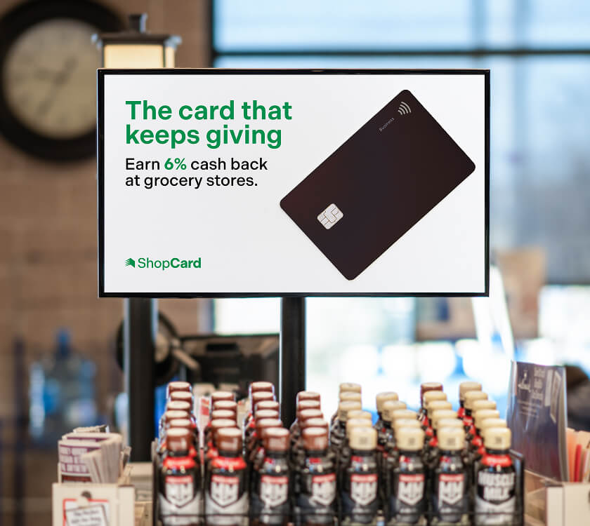Image of a digital screen showcasing a finance brand at the grocery store front end
