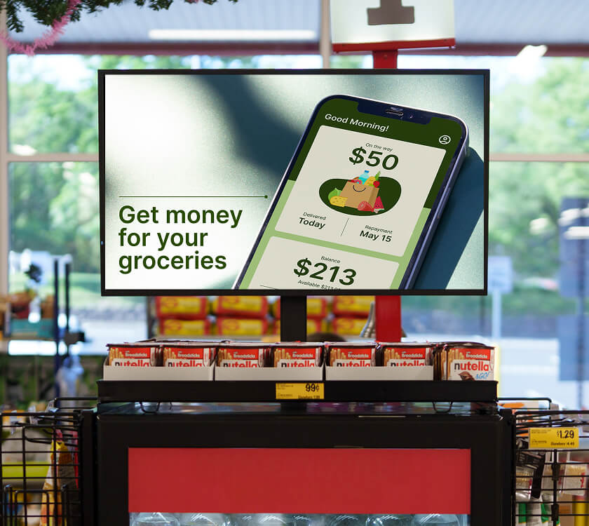 Image of a digital screen showcasing a FinTech brand at the grocery store front end